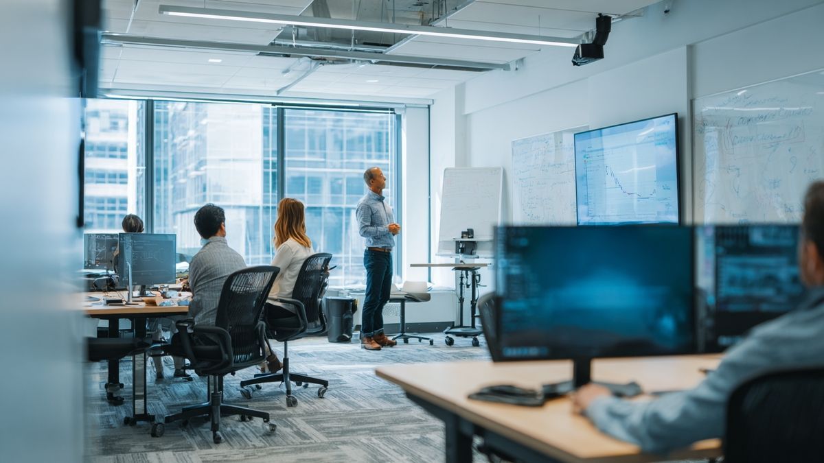 Financial analysts discussing Coinbase’s potential in a modern office with whiteboards