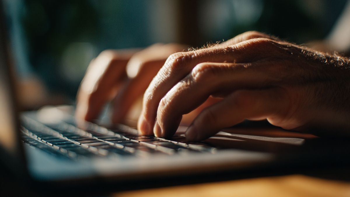 Closeup of hands typing as they explore stablecoins' impact on the UK's financial sector.